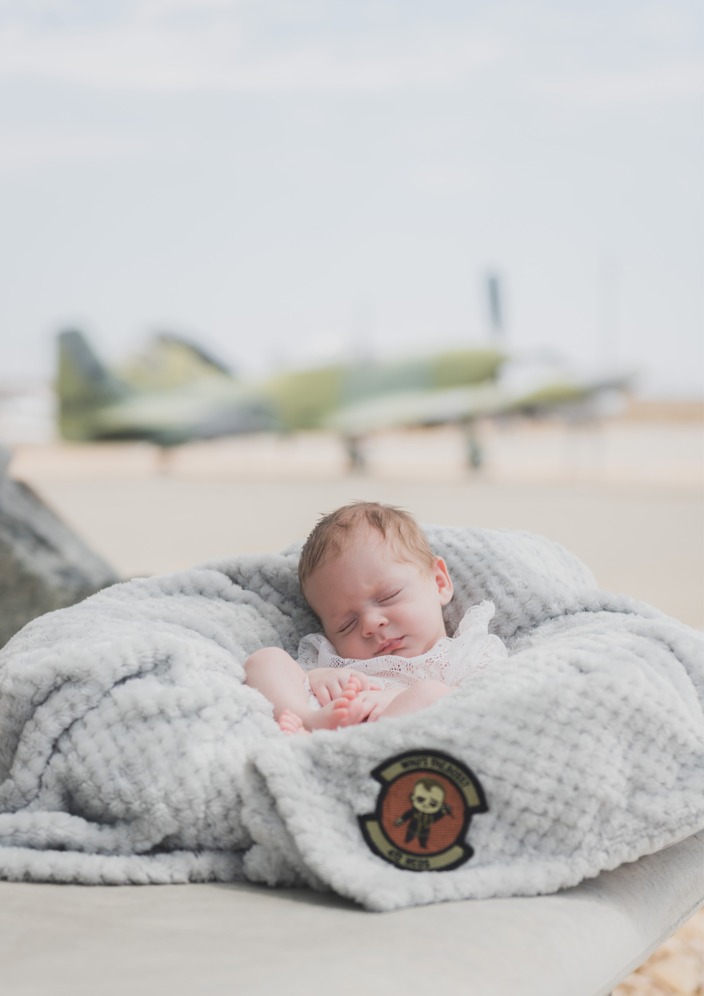light and airy shoots of a marine baby shot on the air force base in southern california. Baby looks happy in her shoot with the high deserts best child photographer
