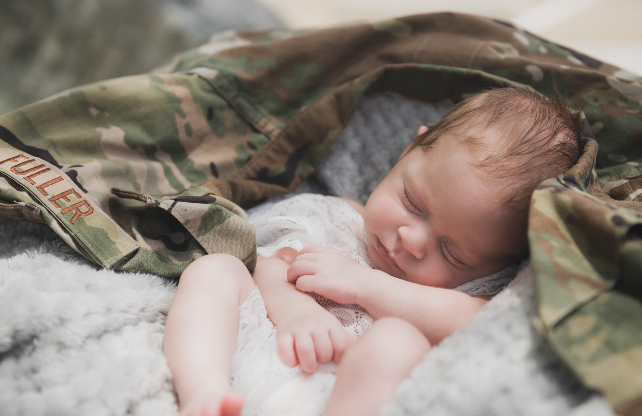 light and airy shoots of a marine baby shot on the air force base in southern california. Baby looks happy in her shoot with the high deserts best child photographer